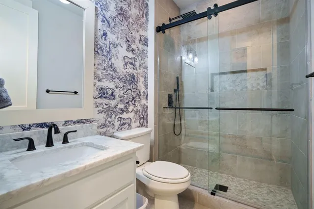 a bathroom with a sink toilet and shower