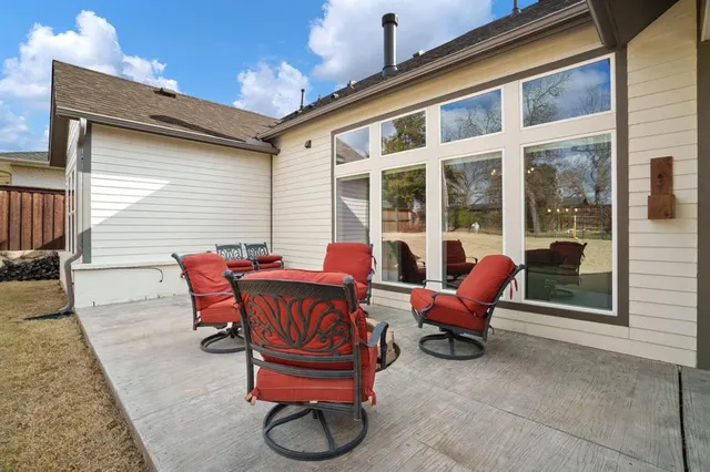 a view of a house with backyard and sitting area
