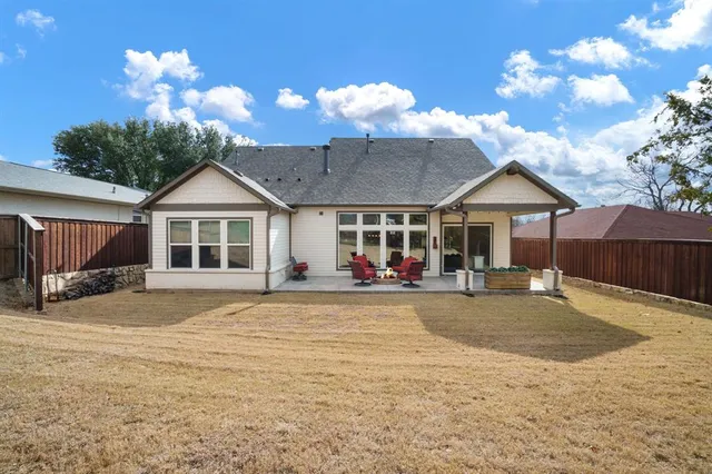 a view of a house with backyard and sitting area