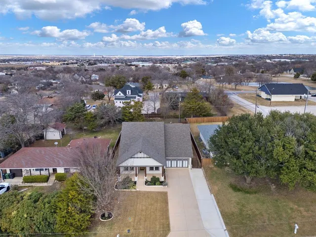 an aerial view of a house with a yard