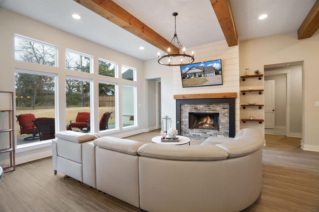 313 East 3rd Street Prosper, TX 75078 - Photo 5 of 38 a living room with furniture a window and a fireplace