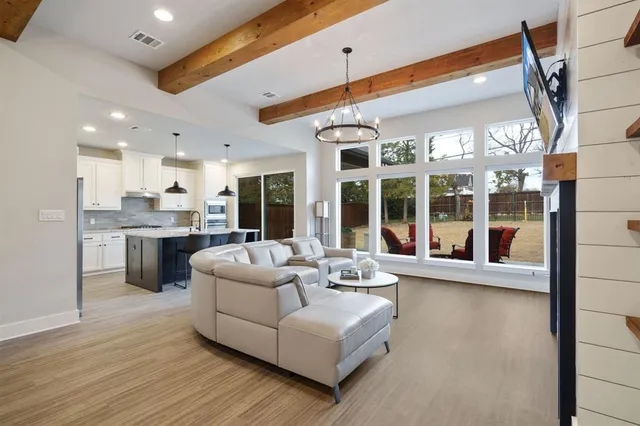 a living room with furniture and large windows