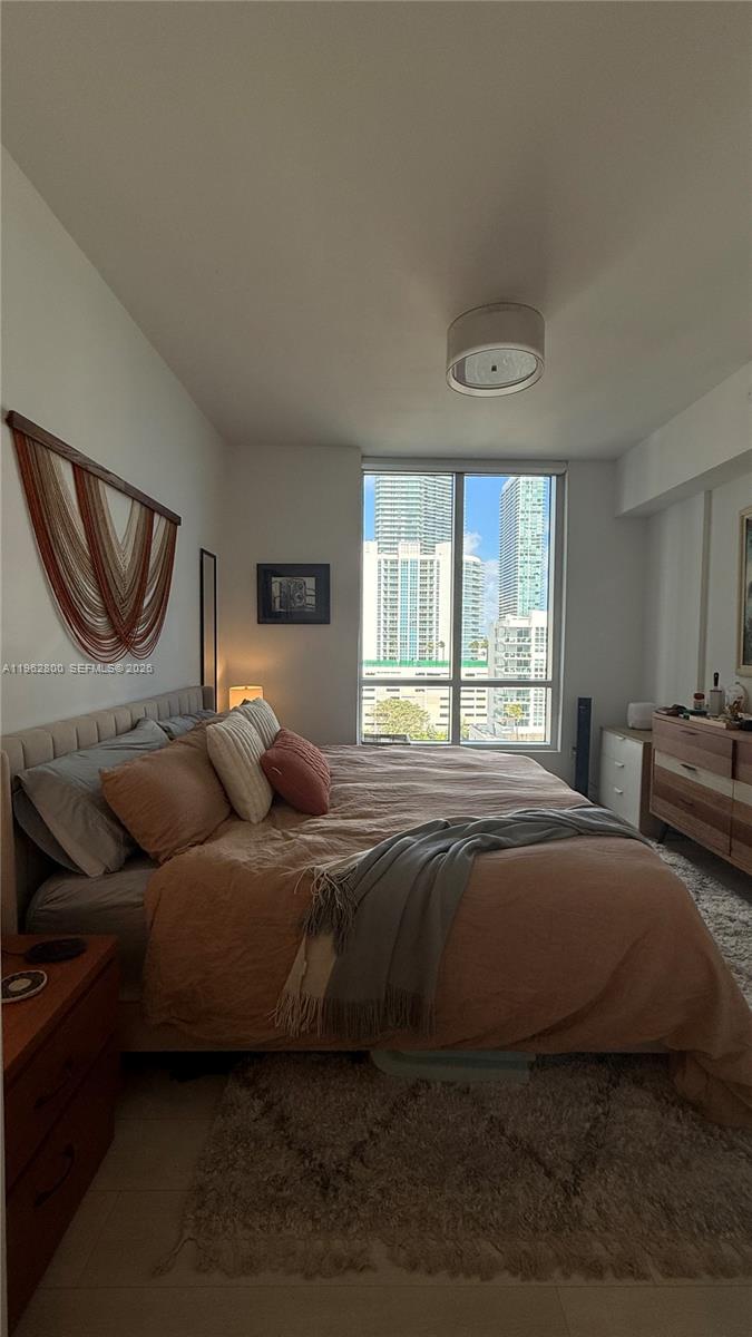 601 Northeast 27th Street, Unit 1003 Miami, FL 33137 - Photo 11 of 31 a bedroom with a bed couch and window