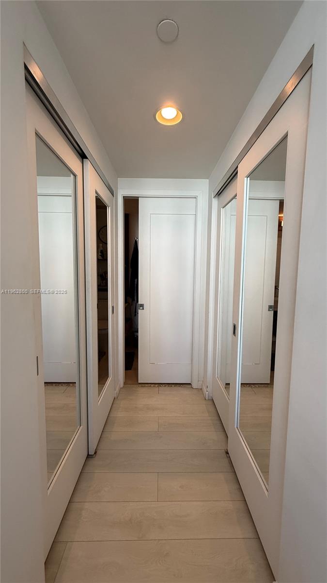 601 Northeast 27th Street, Unit 1003 Miami, FL 33137 - Photo 12 of 31 a view of a hallway with wooden shelves