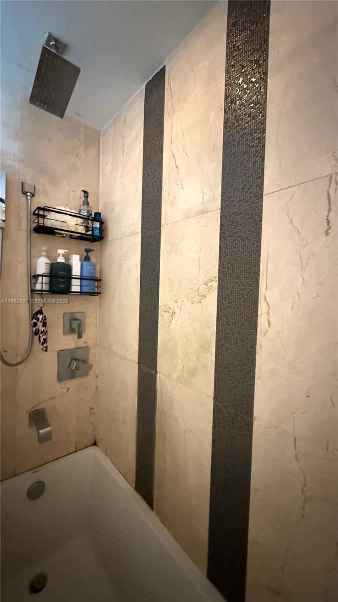 601 Northeast 27th Street, Unit 1003 Miami, FL 33137 - Photo 15 of 31 a bathroom with a shower and a sink