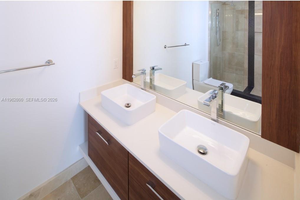 601 Northeast 27th Street, Unit 1003 Miami, FL 33137 - Photo 23 of 31 a bathroom with a sink and a mirror