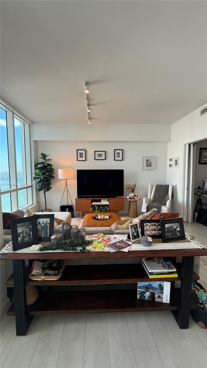 601 Northeast 27th Street, Unit 1003 Miami, FL 33137 - Photo 7 of 31 a living room with furniture and a fireplace