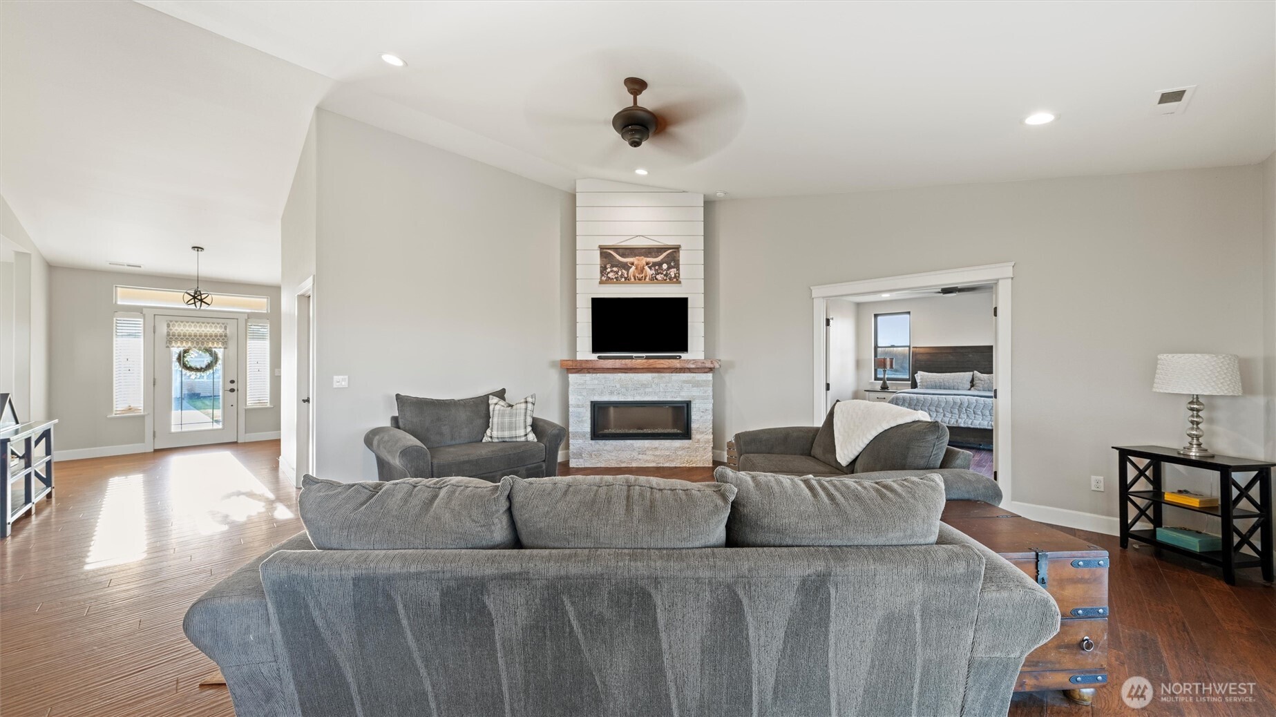1279 Woodward Canyon Road Touchet, WA 99360 - Photo 14 of 35 a living room with furniture a fireplace and a flat screen tv