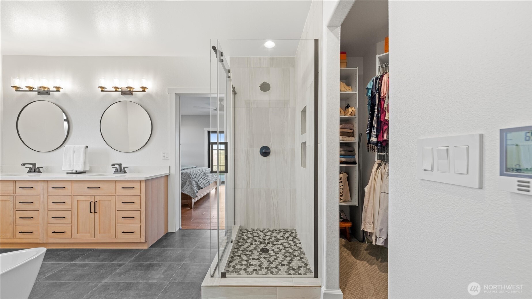 1279 Woodward Canyon Road Touchet, WA 99360 - Photo 18 of 35 a bathroom with a double vanity sink a mirror and a shower