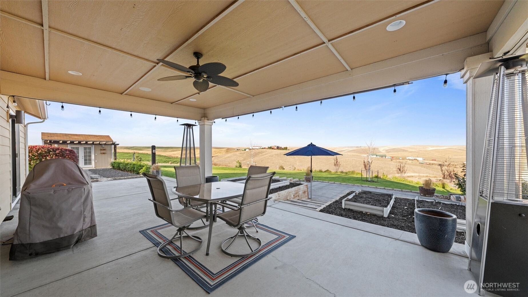 1279 Woodward Canyon Road Touchet, WA 99360 - Photo 26 of 35 a view of a patio with a table and chairs