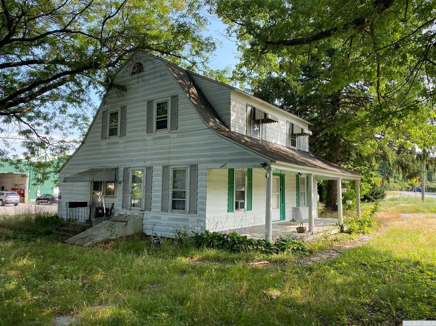 413 Stone Mill Road Claverack, NY 12534 - Photo 1 of 18 a front view of a house with a garden
