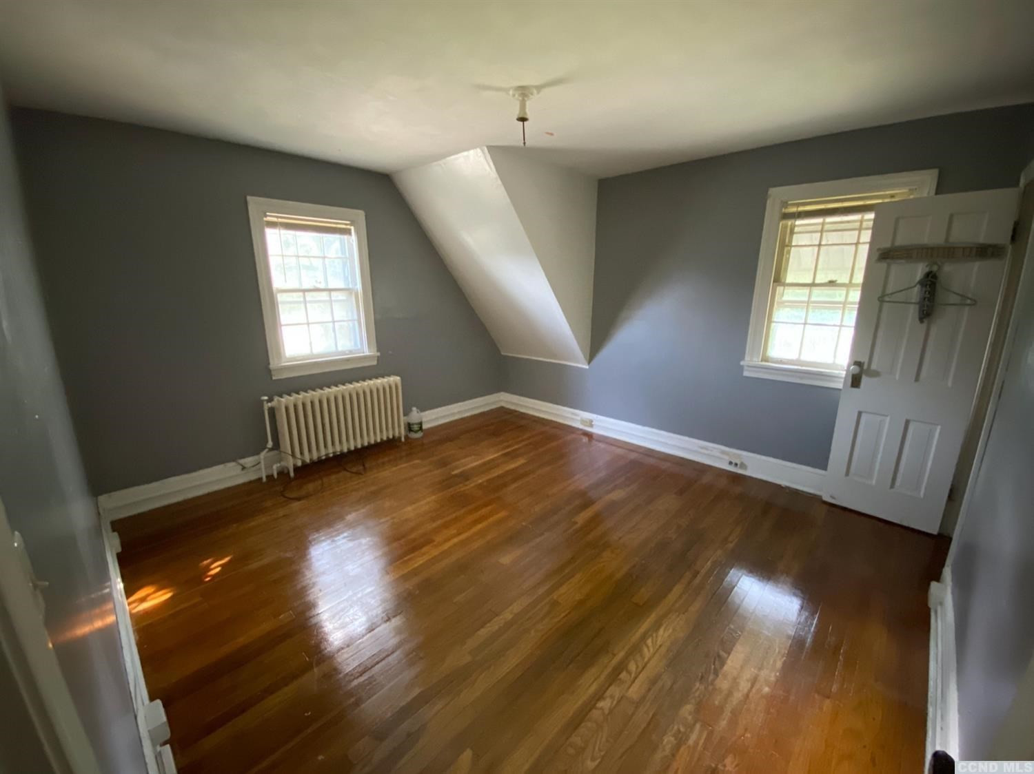 413 Stone Mill Road Claverack, NY 12534 - Photo 14 of 18 a view of an empty room with wooden floor and a window