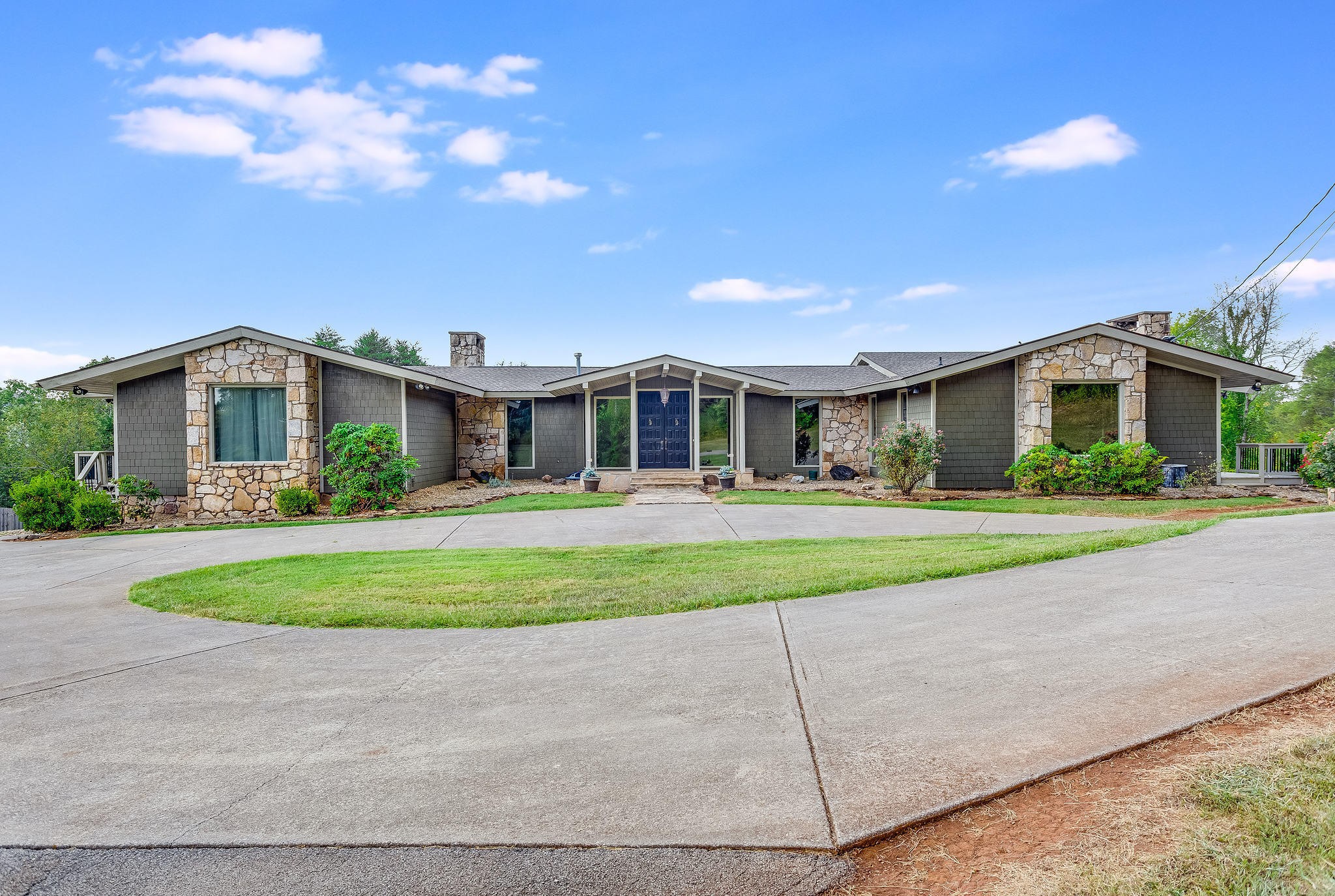 a front view of house with yard and green space