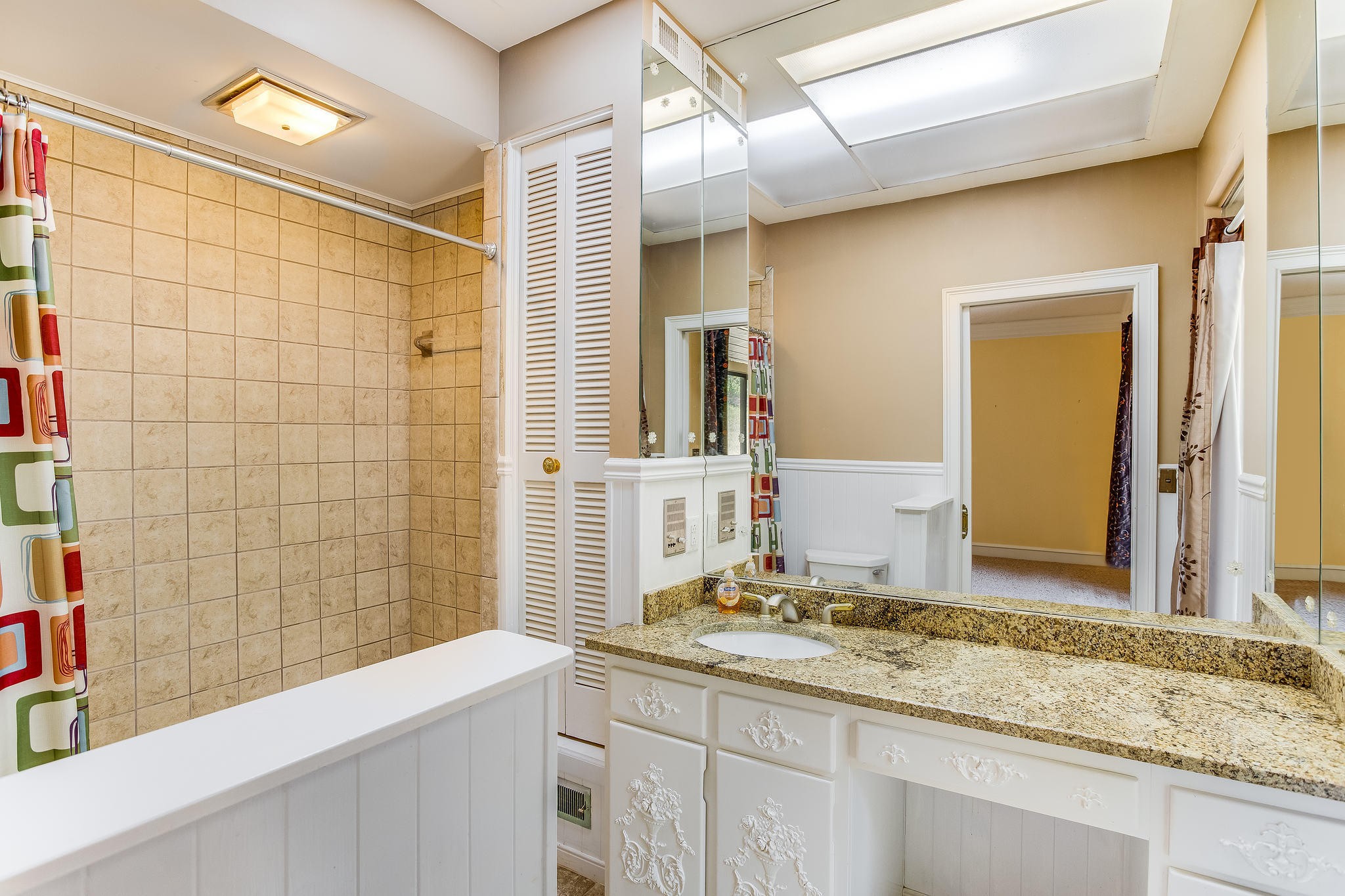 601 Self Hollow Road Rockford, TN 37853 - Photo 23 of 40 a bathroom with a granite countertop sink and a mirror