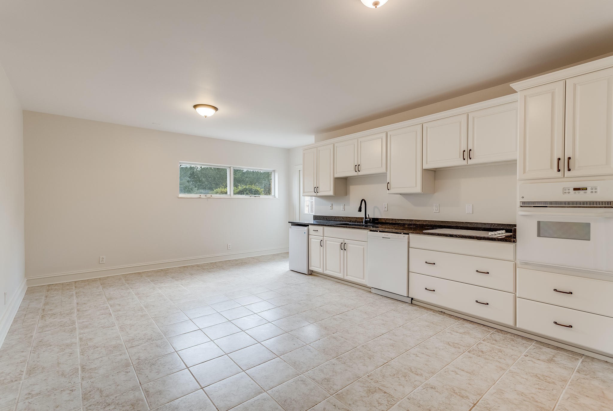 601 Self Hollow Road Rockford, TN 37853 - Photo 36 of 40 a kitchen with granite countertop white cabinets and stainless steel appliances