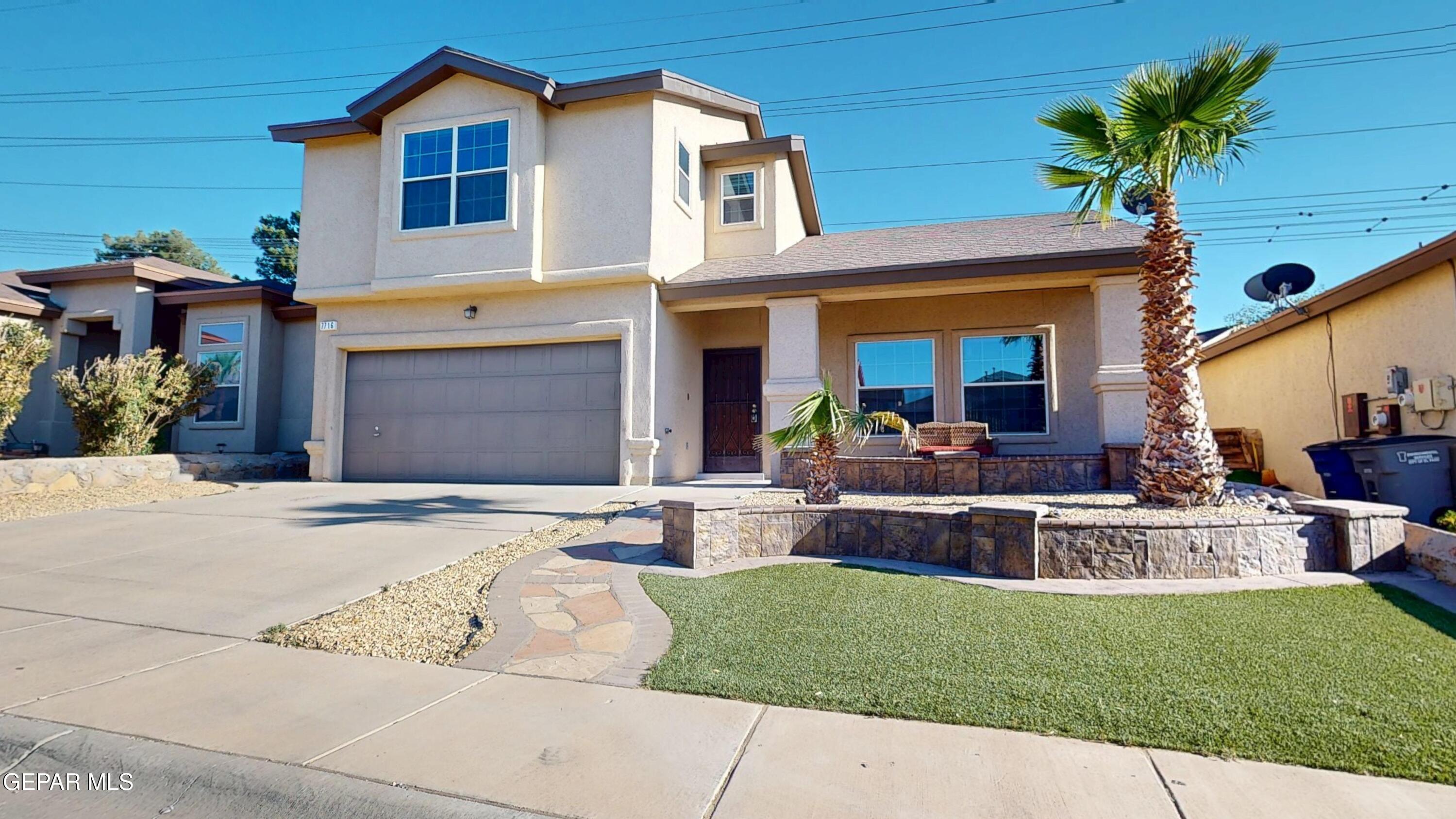7716 Maple Landing Court El Paso, TX 79912 - Photo 1 of 1 a front view of a house with a yard and porch