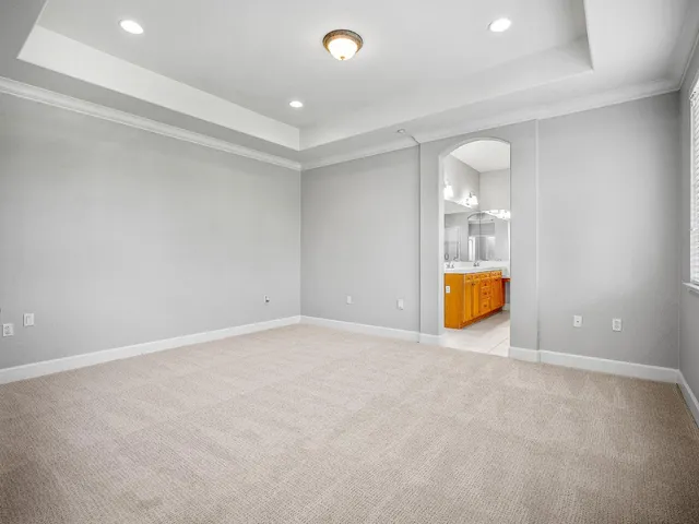 a view of an empty room with a kitchen