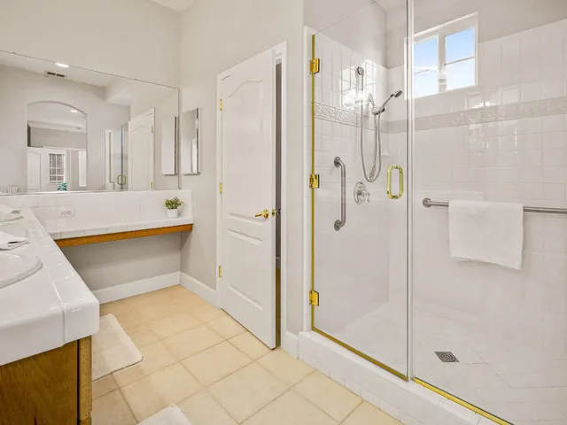 a bathroom with a tub shower and sink