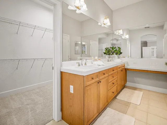 a bathroom with a sink double vanity and a mirror