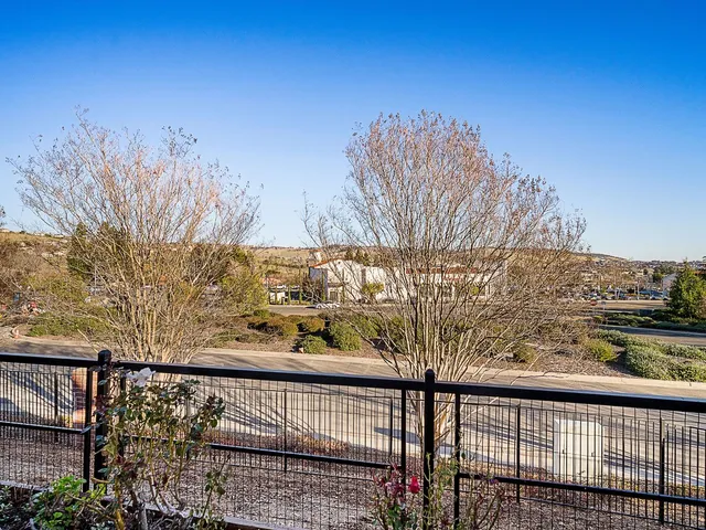 a view of a balcony with trees