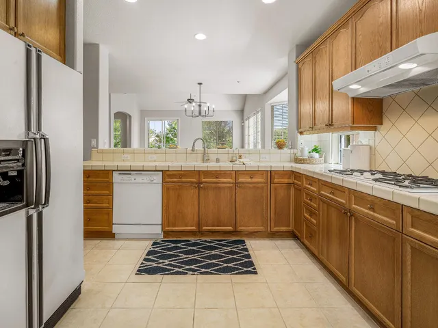 a kitchen with a sink window and cabinets