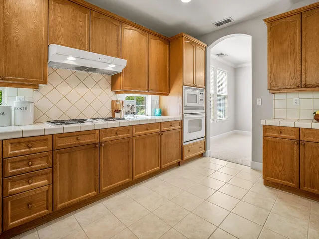 a kitchen with stainless steel appliances a cabinets and a refrigerator