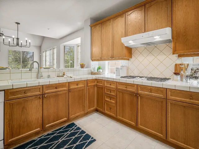 a kitchen with sink cabinets and window