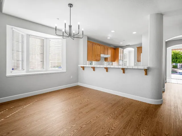 a view of a kitchen with wooden floor and window