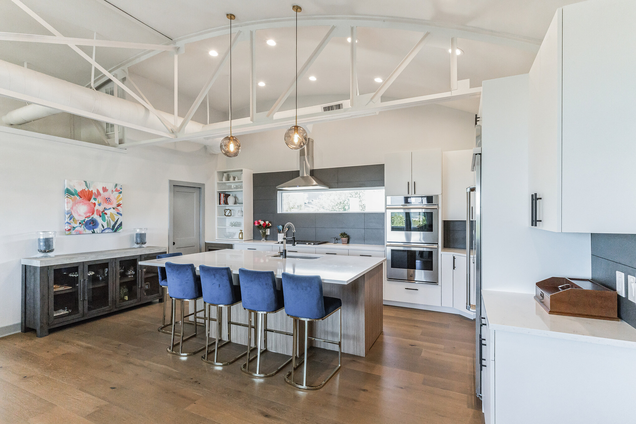4227 Eck Lane Austin, TX 78734 - Photo 5 of 30 Kitchen with white cabinetry, a kitchen breakfast bar, an island with sink, stainless steel appliances, and pendant lighting