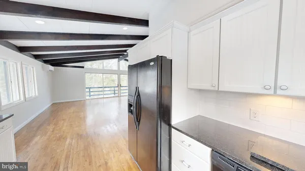 a kitchen with a refrigerator and window