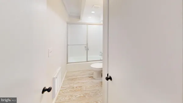 a white toilet next to a bathroom sink