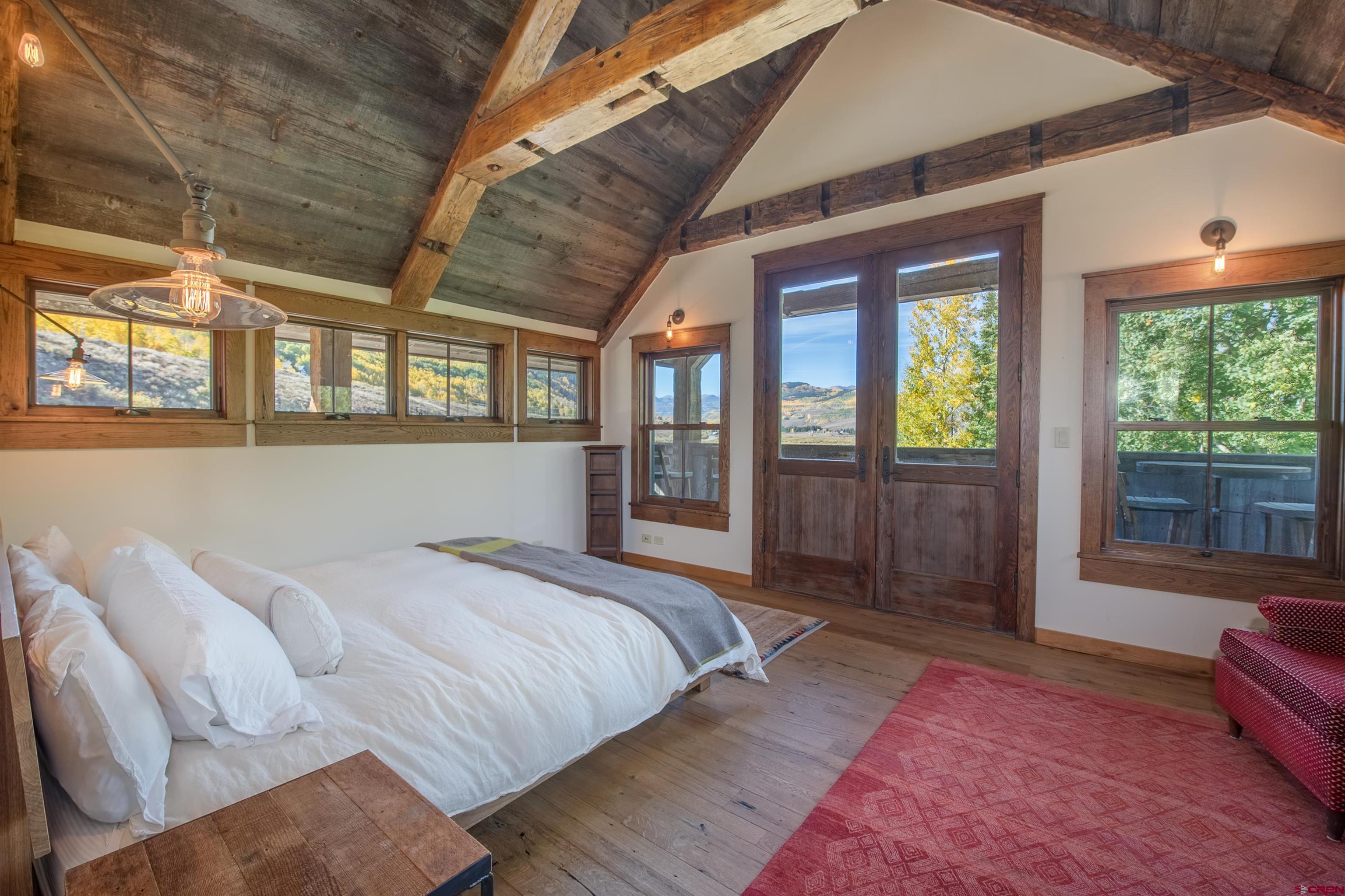 1 Teocalli Avenue Crested Butte, CO 81224 - Photo 16 of 35 a bed sitting in a bedroom next to a window