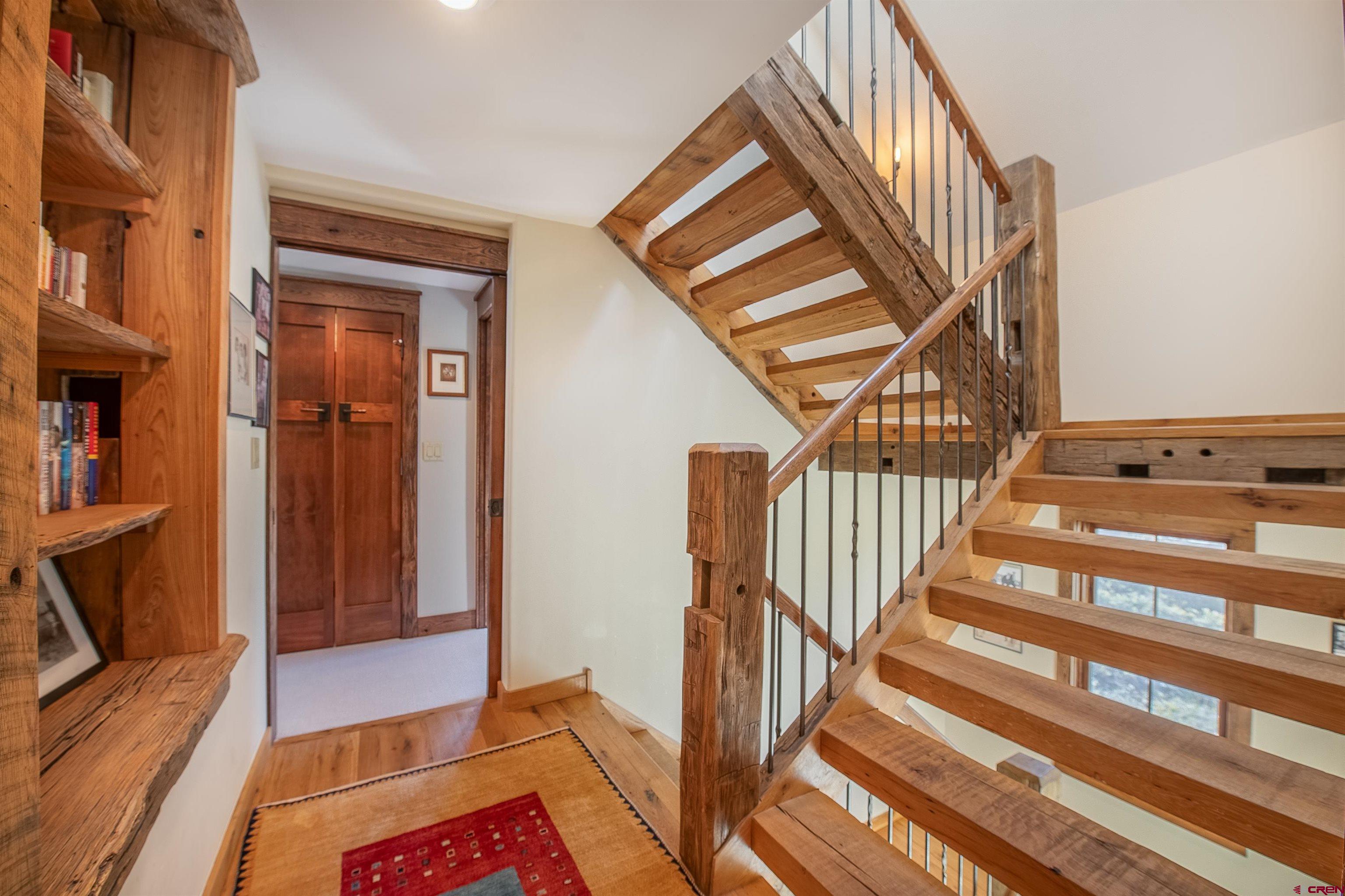 1 Teocalli Avenue Crested Butte, CO 81224 - Photo 19 of 35 a view of stairs and an entryway with wooden floor