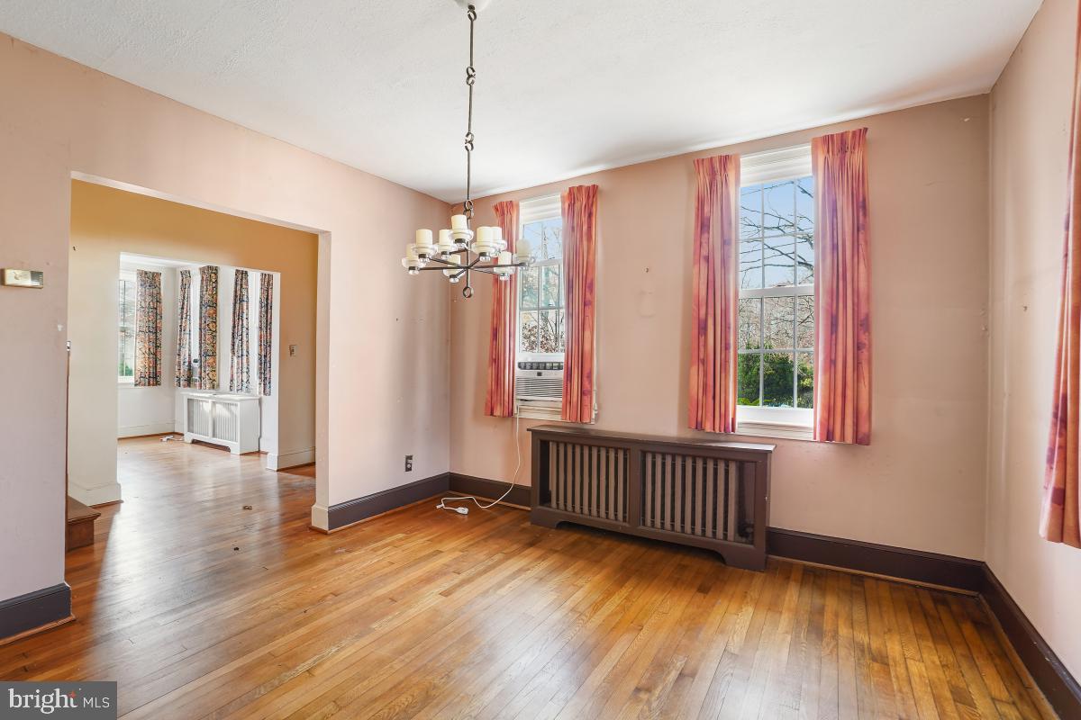 6540 Wiscasset Road Bethesda, MD 20816 - Photo 12 of 33 a view of an empty room with wooden floor and a window