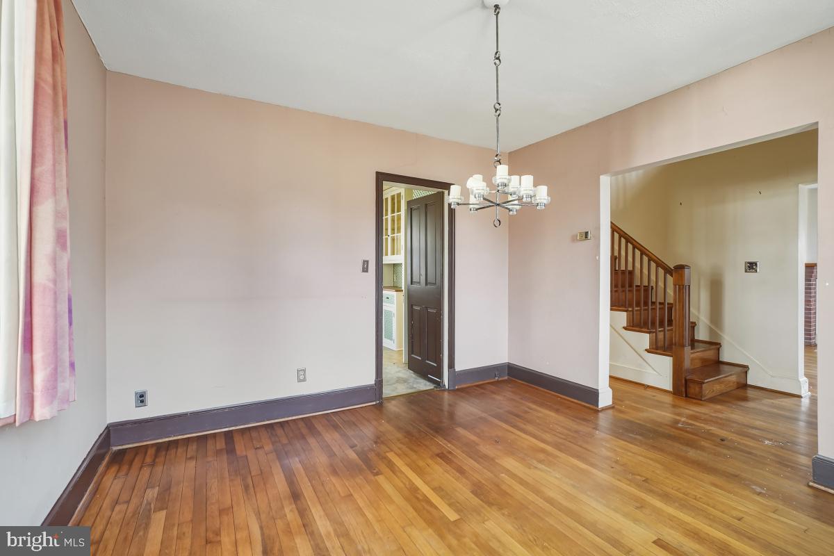 6540 Wiscasset Road Bethesda, MD 20816 - Photo 13 of 33 a view of a livingroom with wooden floor and a chandelier