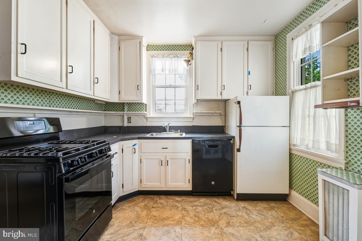 6540 Wiscasset Road Bethesda, MD 20816 - Photo 15 of 33 a kitchen with stainless steel appliances granite countertop a stove a refrigerator and a sink