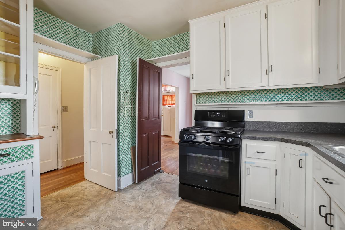 6540 Wiscasset Road Bethesda, MD 20816 - Photo 16 of 33 a kitchen with granite countertop white cabinets and stainless steel appliances