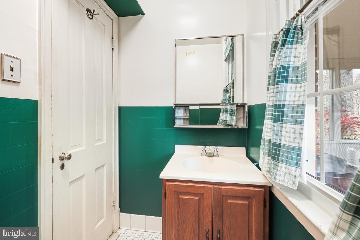 6540 Wiscasset Road Bethesda, MD 20816 - Photo 20 of 33 a view of bathroom with a sink and a mirror