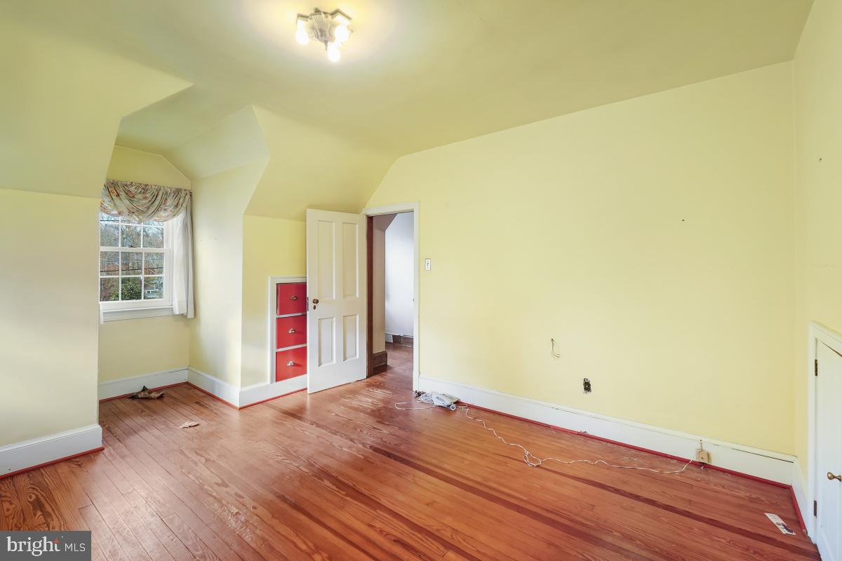 6540 Wiscasset Road Bethesda, MD 20816 - Photo 25 of 33 an empty room with wooden floor and windows