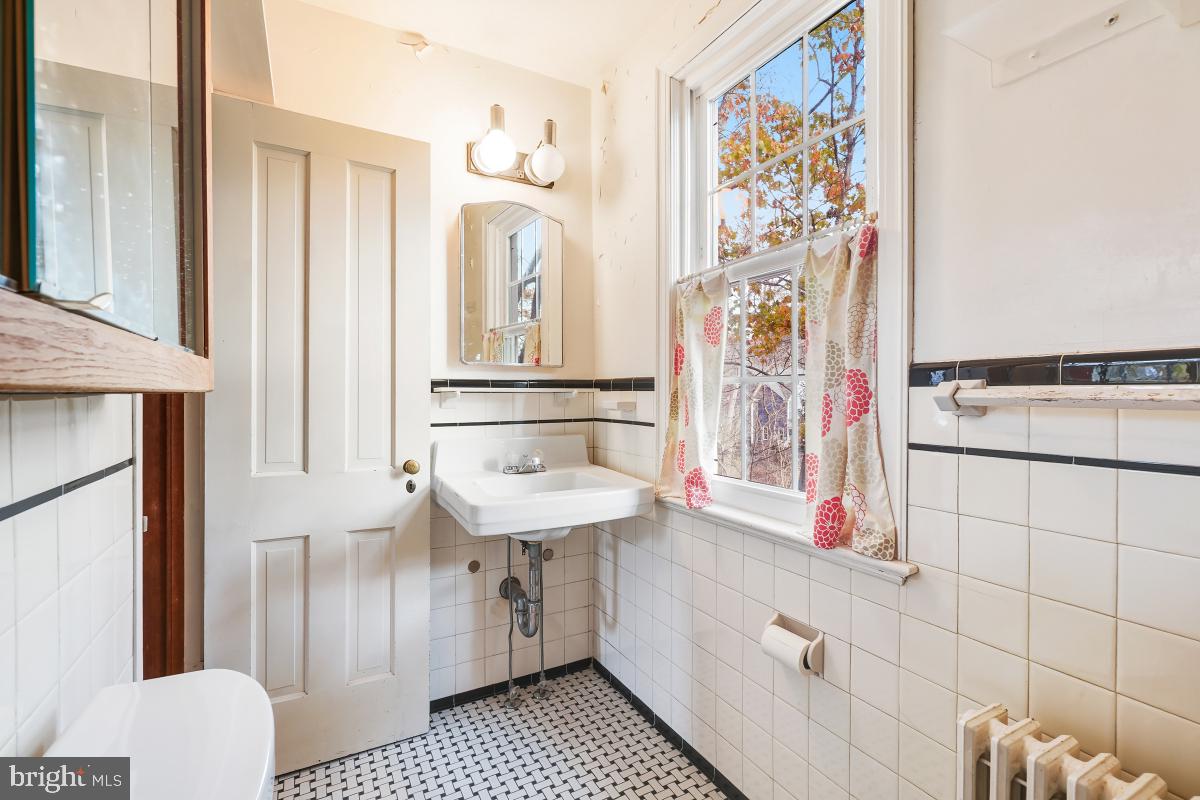 6540 Wiscasset Road Bethesda, MD 20816 - Photo 26 of 33 a bathroom with a sink and a mirror
