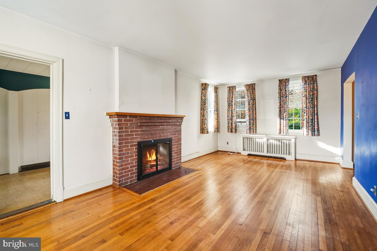 6540 Wiscasset Road Bethesda, MD 20816 - Photo 10 of 33 a view of an empty room with wooden floor and a window