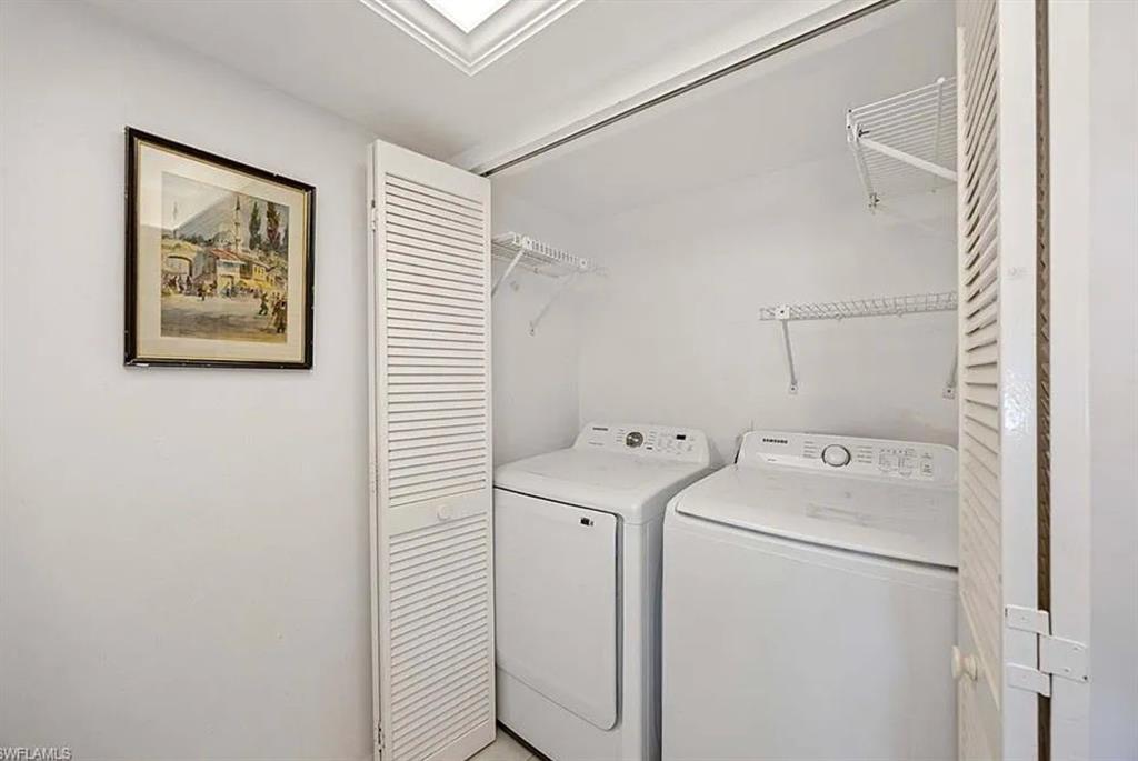 209 Bobolink Way, Unit A Naples, FL 34105 - Photo 12 of 23 a utility room with dryer and washer