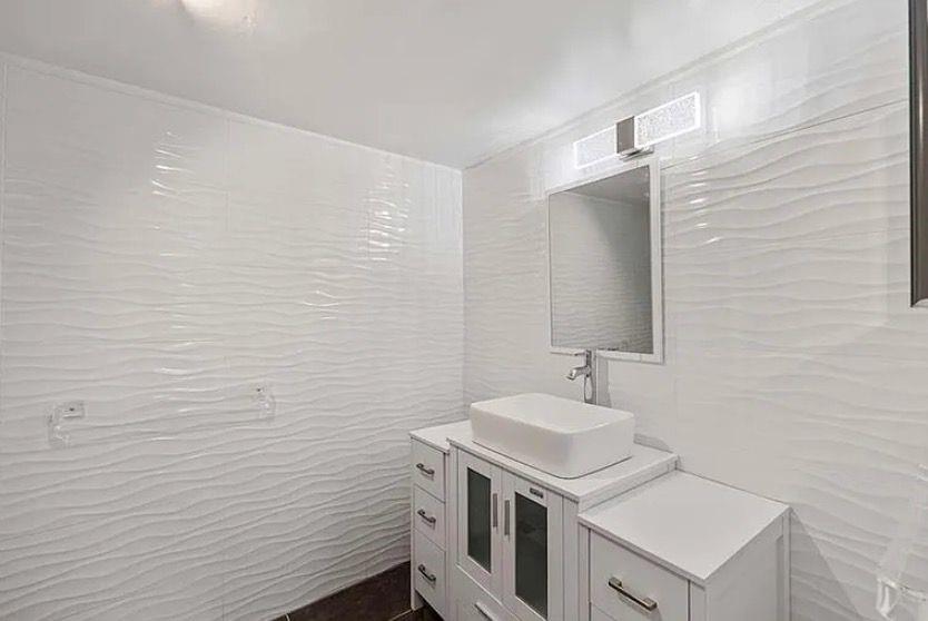 209 Bobolink Way, Unit A Naples, FL 34105 - Photo 16 of 23 a bathroom with a sink a toilet and vanity