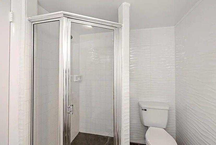 209 Bobolink Way, Unit A Naples, FL 34105 - Photo 17 of 23 a bathroom with a shower and a toilet