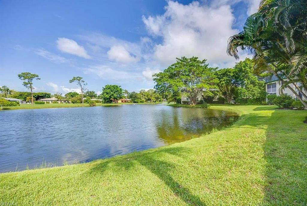 209 Bobolink Way, Unit A Naples, FL 34105 - Photo 23 of 23 a view of a lake with a big yard
