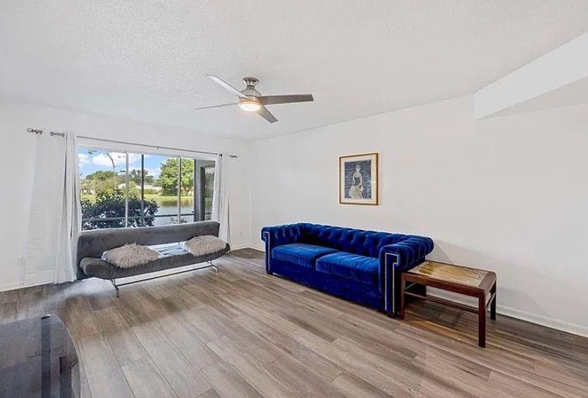 209 Bobolink Way, Unit A Naples, FL 34105 - Photo 4 of 23 a living room with furniture and a large window