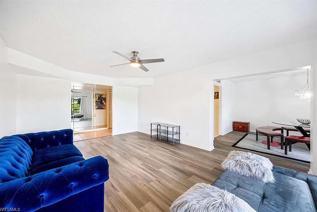 209 Bobolink Way, Unit A Naples, FL 34105 - Photo 7 of 23 a bedroom with furniture and wooden floor