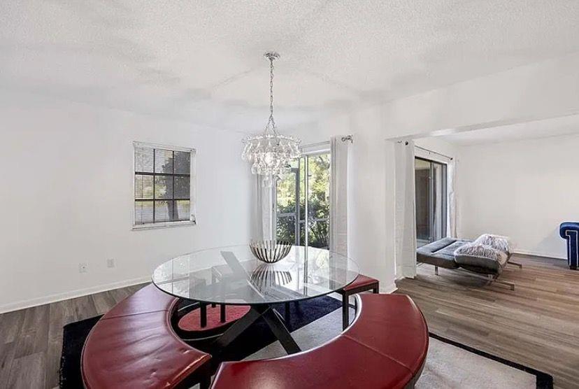 209 Bobolink Way, Unit A Naples, FL 34105 - Photo 8 of 23 a dining room with furniture and window
