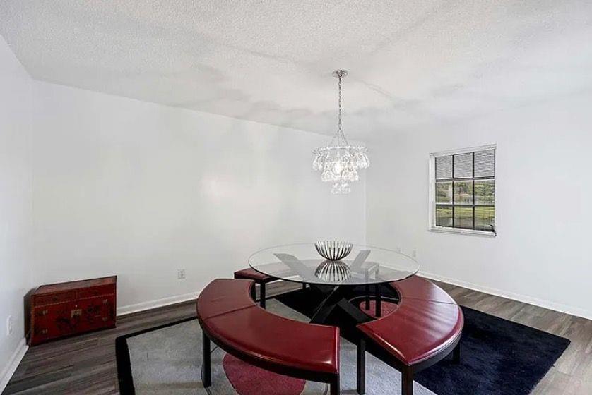 209 Bobolink Way, Unit A Naples, FL 34105 - Photo 9 of 23 a view of a dining room with furniture and wooden floor