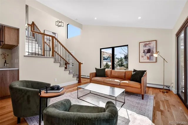 a living room with hard wood floors and furniture